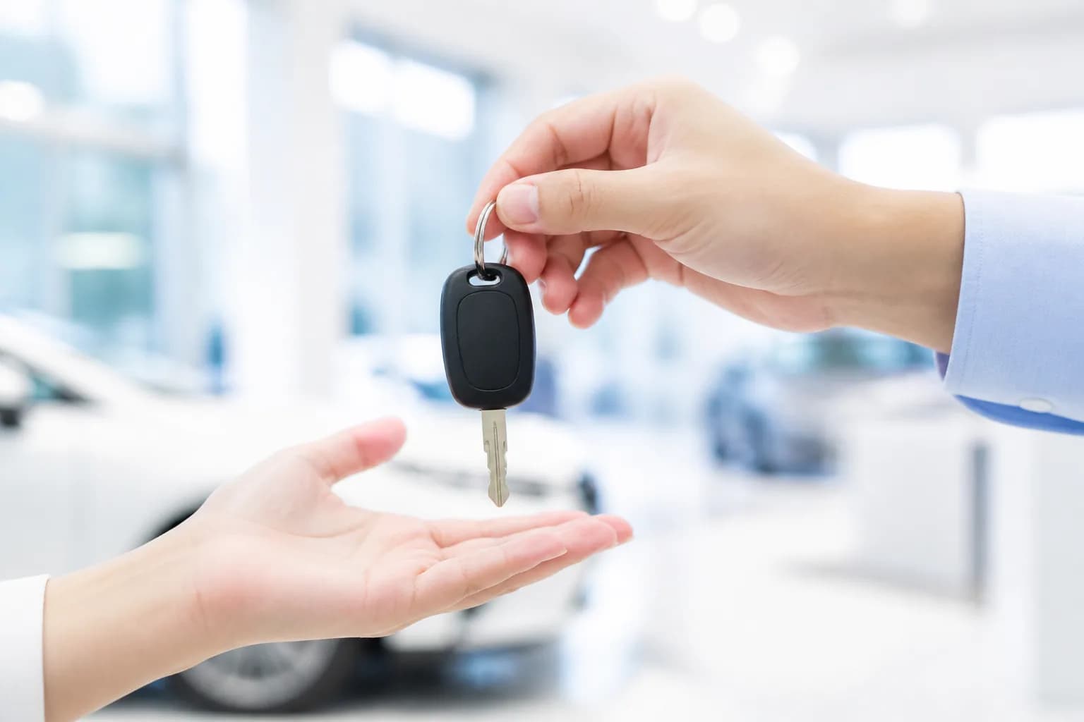 A set of keys passing from one hand to another